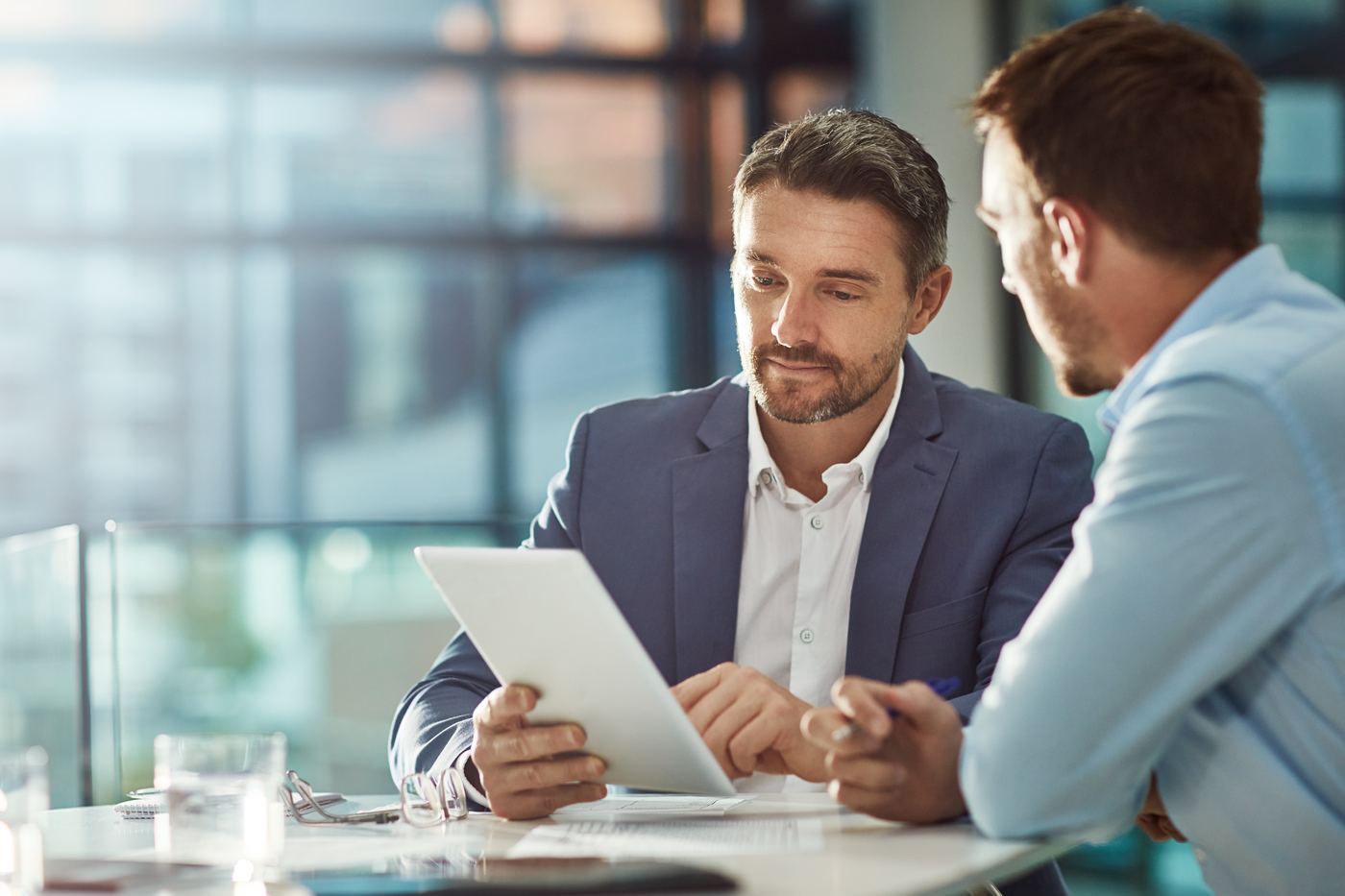 Two people reviewing information together at a desk