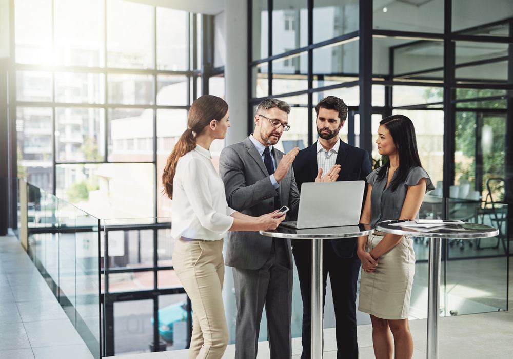 A small leadership team talking together in an office